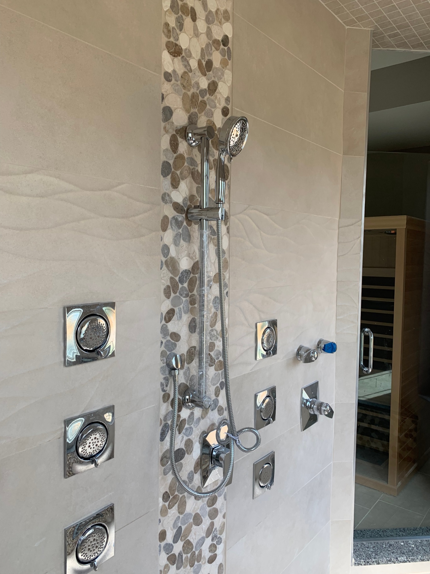 Mullica Hill Residence — primary bath shower with pebble mosaic inlay