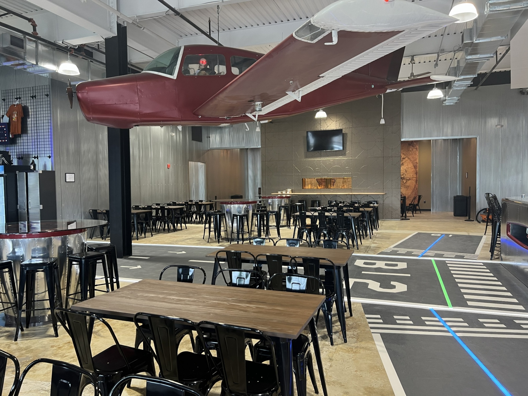 Bonesaw Brewing Deptford — suspended aircraft over the taproom floor