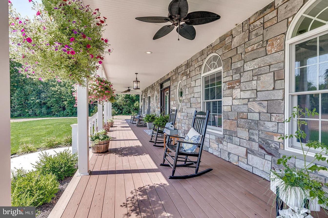South Harrison Residence — wraparound porch with stone façade