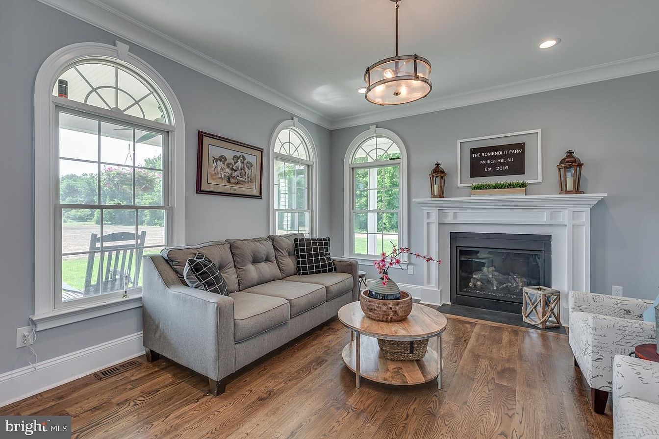 South Harrison Residence — sitting room with arched windows and fireplace