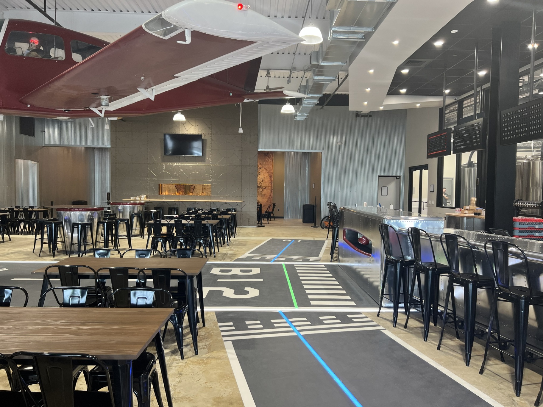 Bonesaw Brewing Deptford — LED runway markings in the floor and the aircraft-skin bar