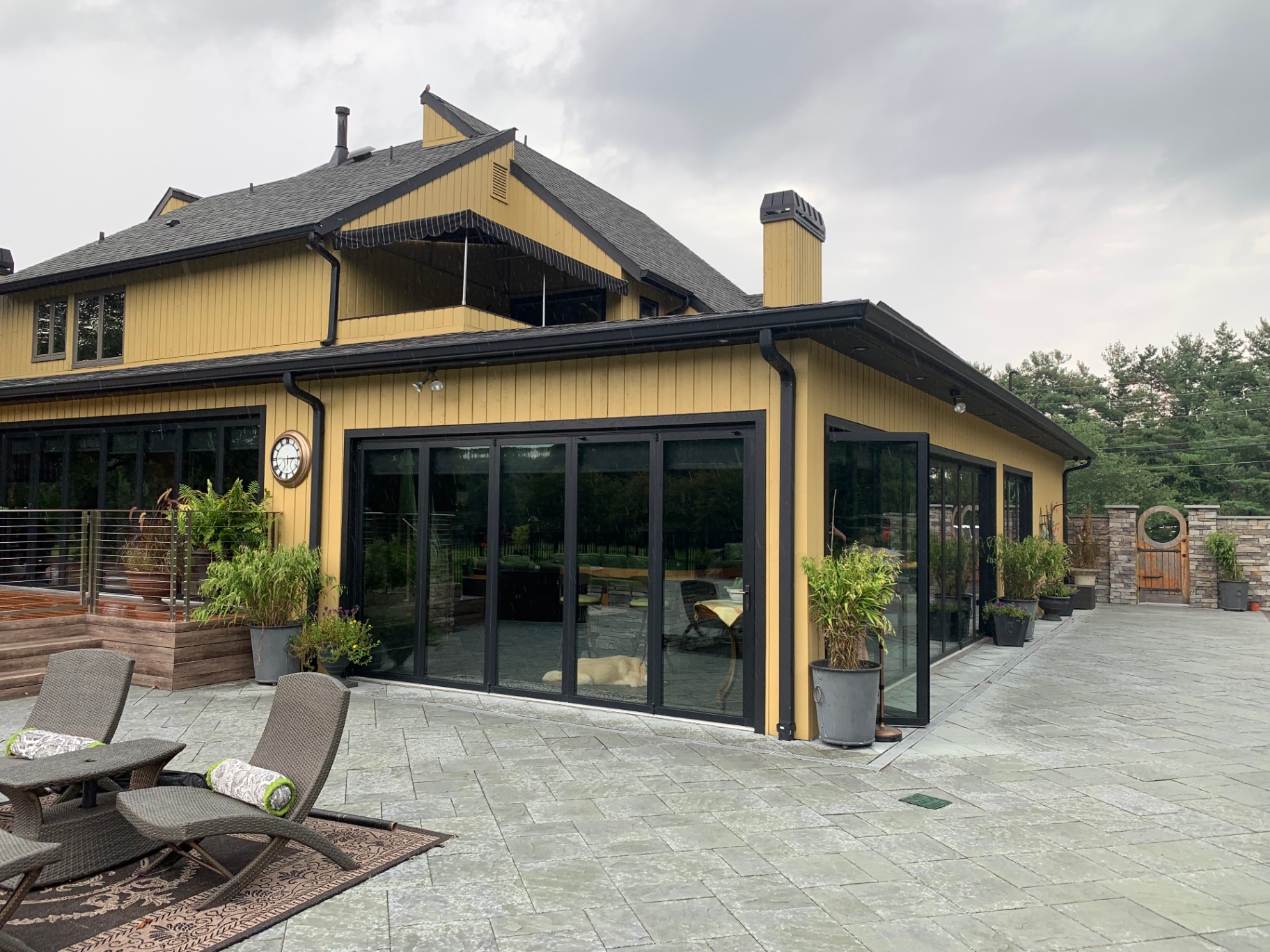 Moorestown Custom Addition — exterior with folding glass walls and stone patio