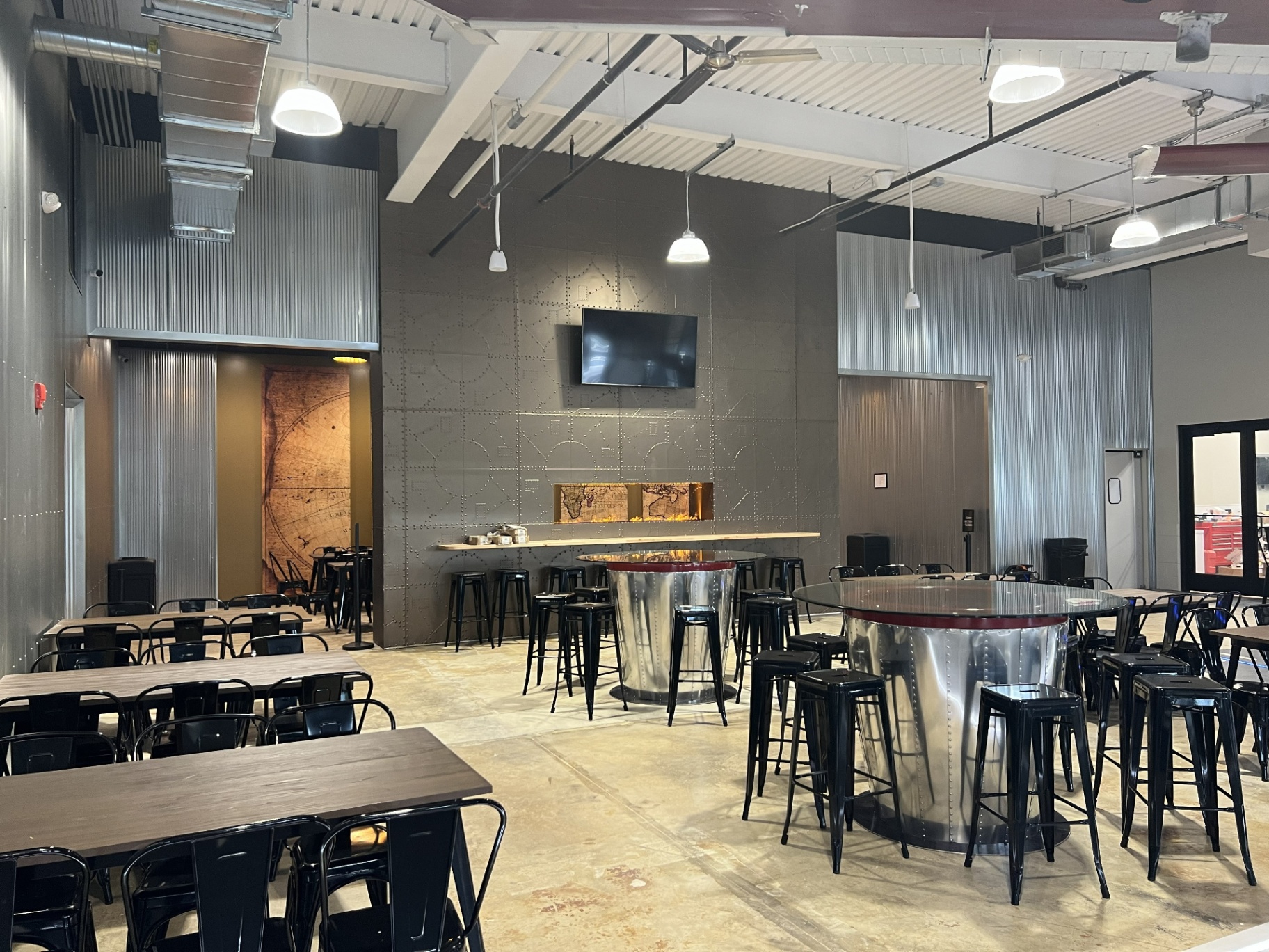 Bonesaw Brewing Deptford — riveted map wall and fireplace niche